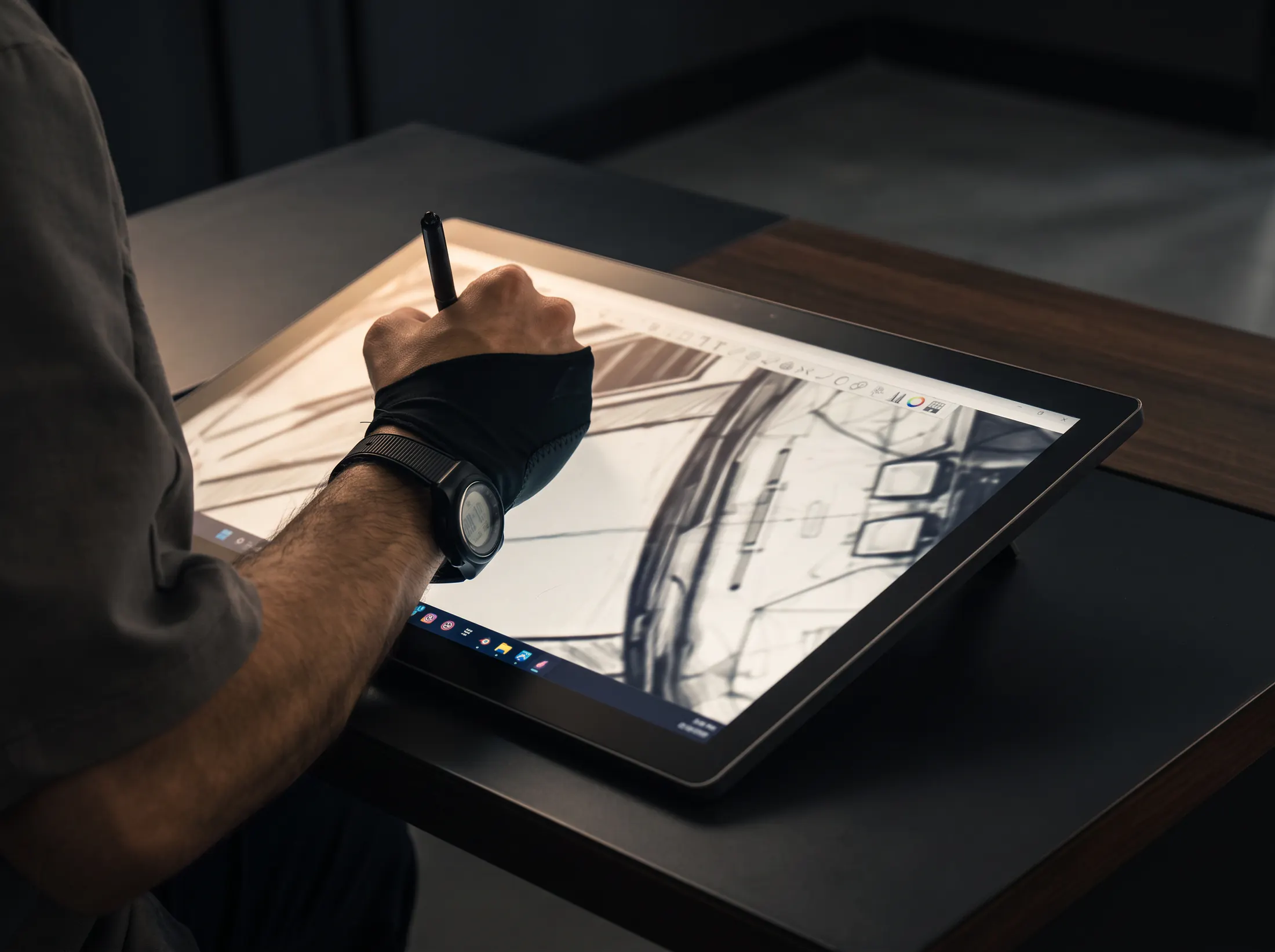 Designer sketching a car on a drawing tablet
