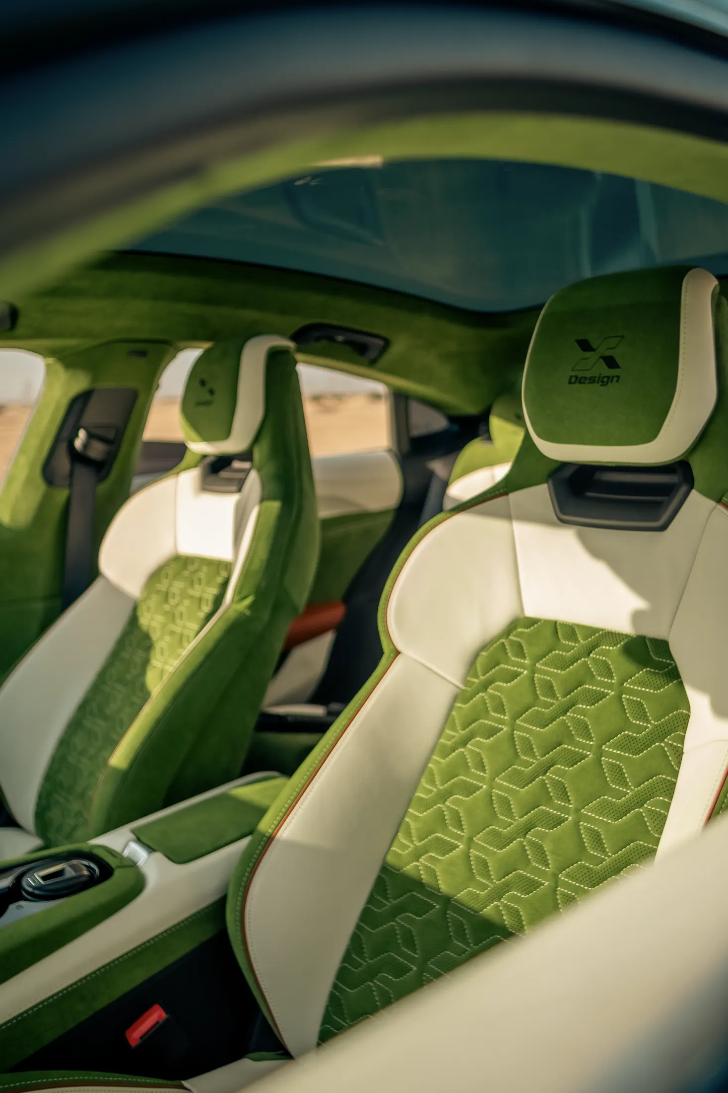 Retrimmed front seats in embossed green suede and cream leather