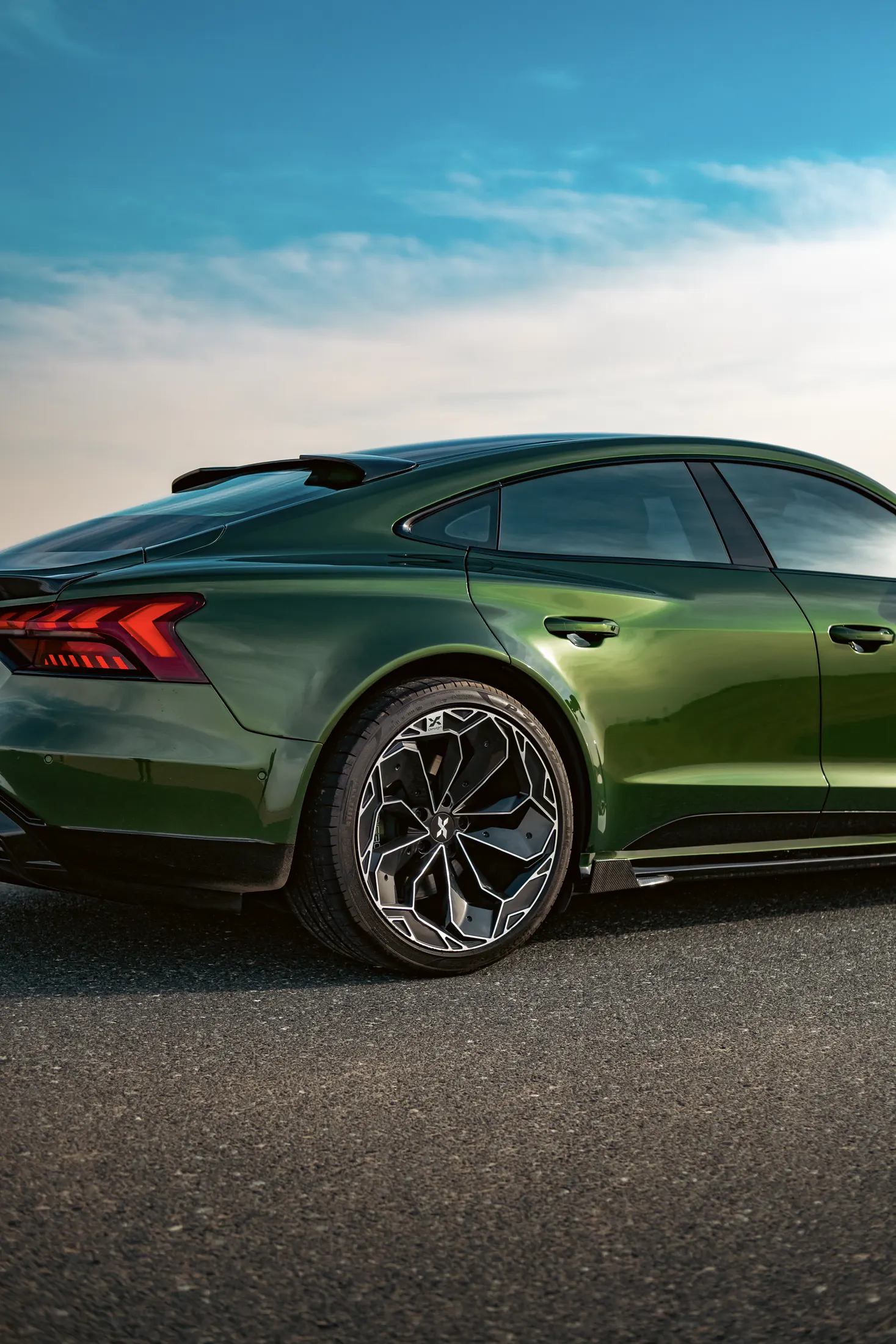 Audi RS e-tron GT, rear three-quarter on a desert road